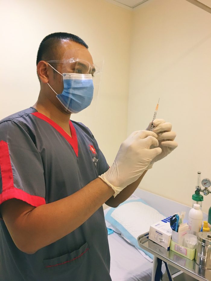 Dark-Skinned Nurse With Vaccine Photo