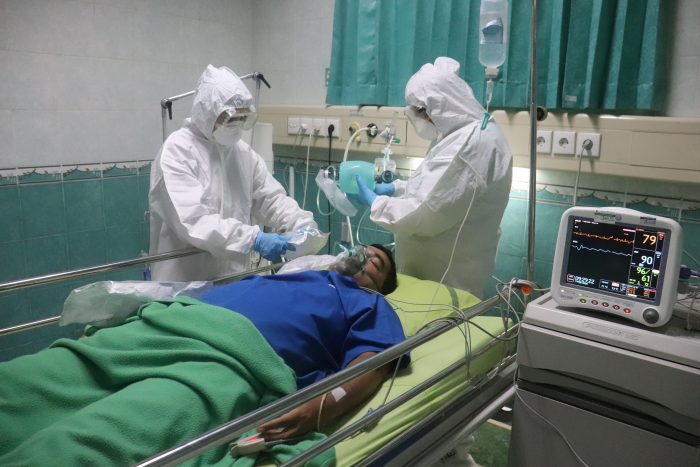 Doctors Treating Covid Patient on Ventilator Photo